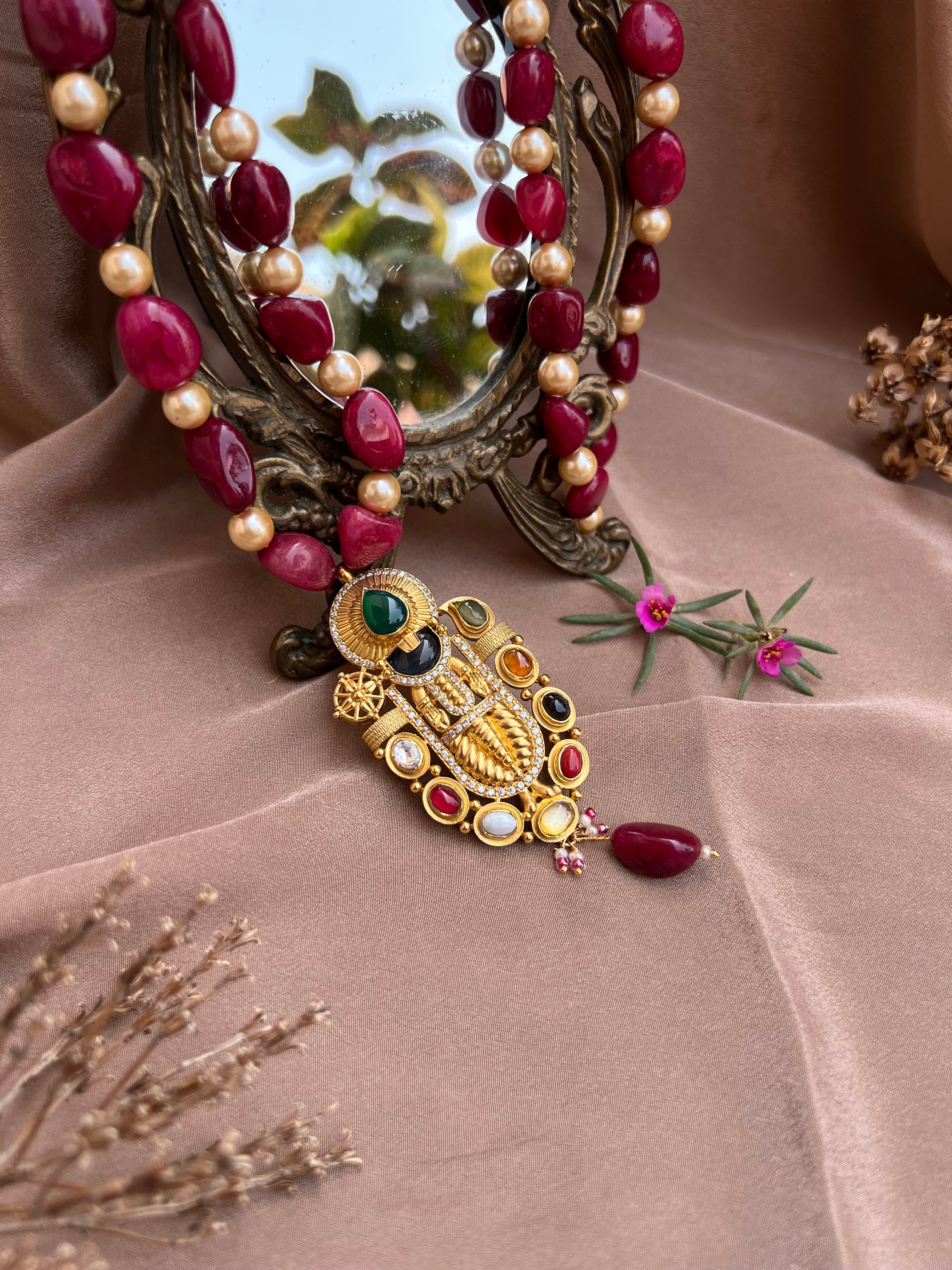 Navarathna studded Balaji pendant.